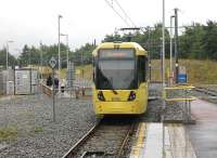 A Metrolink tram leaves the temporary Oldham Mumps stop heading for Rochdale in July 2013. For an approximate Then and Now comparison at this location five years earlier [see image 21173]. This temporary stop closed on 18th January 2014 and the lines and catenary were removed completely by August that year. The area will be redeveloped now the new town centre street running section is open. <br><br>[Mark Bartlett 31/07/2013]