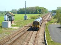 A York to Blackpool service, formed by 158909, approaches Salwick station on 22 May 2012. On the left is Salwick No 2 SB which is scheduled for closure with the electrification of the line from Preston to Blackpool North. On the right the loop remains, along with the ground frame and point leading to theformer sidings in the Westinghouse, Springfields industrial complex.<br><br>[John McIntyre 22/05/2012]