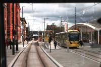 One of three brand new town centre tram stops, this is Oldham Central, opened in January 2014. Tram 3050 is leaving for Manchester on 13 February, seen from a Rochdale bound service.<br><br>[Mark Bartlett 13/02/2014]