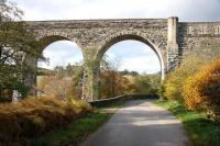 The castellated north end of the 1863 Edinkillie Railway Viaduct over the River Divie in Morayshire, complemented by the surrounding autumn colours in October 2005. The grade B listed structure, generally referred to as The Divie Viaduct,  is located between Dava and Dunphail and now forms part of The Dava Way. [See image 5793]<br><br>[John Furnevel 31/10/2005]