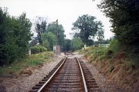 A view along the former Harpenden - Hemel Hempstead line on 7th August 1976. The location is Sunnyside, a minor crossing to the east of Beaumont's Halt. The battered fixed signal is protecting the level crossing at the halt. The line remained in use for occasional ash traffic until 1979.<br><br>[Mark Dufton 07/08/1976]