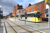 A four-car Metrolink tram leaves the new Oldham Central stop heading for Rochdale on 13 February. Road vehicles are excluded from this particular stretch of the <I>street running</I> section of the new line, which had only opened during the previous month. <br><br>[Mark Bartlett 13/02/2014]