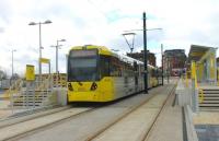Metrolink trams 3039 and 3053, on a Rochdale to East Didsbury service, call at the new Mumps interchange stop just to the east of Oldham town centre. They will climb through the town before dropping steeply down to rejoin the old railway formation at Werneth. [See image 44114] for a view of this location under construction during the previous summer. <br><br>[Mark Bartlett 13/02/2014]