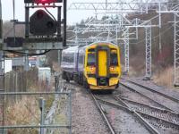 View from the platform at Cumbernauld on 21 February 2014 as a terminated service from Motherwell enters the refuge siding. Changed days.... with colour light signalling and electrification equipment now installed here [see image 10787].<br><br>[Colin Harkins 21/02/2014]