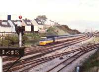 A Westbound BR <I>InterCity 125</I> HST - most likely bound for Cardiff or Swansea - passes the branch to Uskmouth and the semaphore signals for East Usk yard in September 1988. Llanwern steelworks (proposed 1862, built 1962) is in the background.<br><br>[Ken Strachan /09/1988]