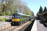 A sunny afternoon on the West Somerset Railway on Sunday 13 April 2014, as an eastbound DMU calls at Crowcombe Heathfield. The train is on its way to Bishops Lydeard.<br><br>[Peter Todd 13/04/2014]