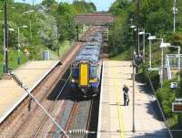 View east from the footbridge at Wallyford on 13 May 2014 as the 12.27 North Berwick - Edinburgh Waverley, formed by ScotRail unit 380105, arrives at the platform.<br><br>[John Furnevel 13/05/2014]