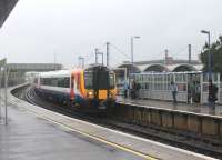 Passengers waiting in very heavy rain at Poole on 23rd May 2014 were glad of the large platform shelters. SWT 444037 pulls in on a stopping service for Waterloo ex-Weymouth. The arched roof sections of the modern station building can be seen to the right of the train.<br><br>[Mark Bartlett 23/05/2014]