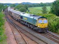 Freightliner 66622 passes Inverkeithing East Junction with Aberdeen - Oxwellmains empties on 24 June.  The two cargowaggons were used for bagged cement.<br><br>[Bill Roberton 24/06/2014]