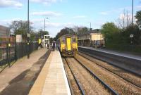 150273 calls at Huyton with a Liverpool to Manchester service on 19 April 2014. On the left work is underway to eventually restore 4 track working from Roby to Huyton Jct just to the east of the station.<br><br>[John McIntyre 19/04/2014]