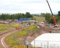 Borders Railway progress at the north end of Millerhill Yard on 26 June 2014.  View south west towards Shawfair, with a new bridge over the trackbed starting to take shape beyond the end of the turnback siding. The bridge will provide access from Whitehill Road into the new recycling plant which is being constructed here.<br><br>[John Furnevel 26/06/2014]