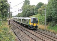 The extra Commonwealth Games traffic has seen Trans Pennine EMUs supplemented by London Midland sets. 350373 is seen here heading south at Barton and Broughton on a Glasgow to Manchester Airport service on 30th July in tandem with TPE 350404.  <br><br>[Mark Bartlett 30/07/2014]