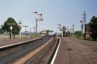 The north end of Manningtree station on 15th August 1976. The semaphores lasted until 1980 and the signal box until 1984. The lorry straddling the tracks is negotiating the level crossing, being too tall for the underpass.<br><br>[Mark Dufton 15/08/1976]