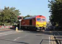The morning commuter traffic is briefly halted on 27 August as DBS 60010 sets off across Strand Road in Preston with the bitumen empties returning to Lindsey refinery. A short distance beyond the crossing lies Fishergate Tunnel and the 1:29 climb back to the main line near Preston station. <br><br>[Mark Bartlett 27/08/2014]