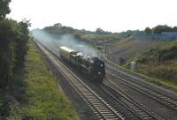 Bulleid rebuilt West Country Pacific no 34046 <I>Braunton</I> coming out of the sun past the Keypoint Railfreight Terminal on the eastern outskirts of Swindon on 19 September 2014 on its way from Bristol to Southall.<br><br>[Peter Todd 19/09/2014]