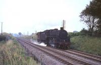 Grangemouth shed's BR standard class 5 4-6-0 no 73007 and guards van, photographed near Cumbernauld on 3 August 1965. <br><br>[G W Robin 03/08/1965]