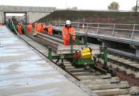 Tracklaying taking place on the down line through Shawfair station on 9 October 2014 as part of a media event. GBRf 66706 <I>Nene Valley</I> is at the north end of the train.<br><br>[John Furnevel 09/10/2014]