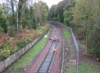The advance guard of the Borders Railway tracklaying train drops rails into place just south of Kingsgate Points in the early afternoon of Monday 13th October. [See image 38706]<br><br>[David Spaven 13/10/2014]