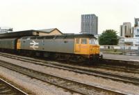 A Railfreight class 47 heads an up parcels train at Cardiff Central in 1988. The awning seems to have suffered from excessive diesel exhaust.<br><br>[Ken Strachan //1988]