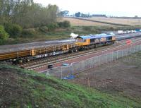 The Borders Railway tracklaying train operating just to the north of Shawfair station on 9 October 2014. The locomotive is GBRf 66706 <I>Nene Valley</I>.  <br><br>[John Furnevel 09/10/2014]