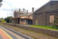The rather spooky looking disused main building and large goods shed on the single track part of the Melbourne - Bendigo line in September 2014. The station is still open with a reasonable train service in both directions.<br><br>[Colin Miller 30/09/2014]
