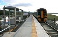 DMU 158826 leaves the almost finished new station at Llandecwyn on 14th October 2014 for Birmingham International. Although some work remains to be done on approaches and handrails, the new station opened for business along with the reconstructed Pont Briwet in September 2014.<br><br>[Colin McDonald 14/10/2014]