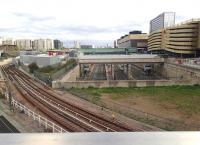View east from Olympic Park Avenue over Stratford International station on 18 September 2014. In the foreground the Docklands Light Railway lines run towards the terminus on the upper left. Just out of shot immediately below the camera is the freight only link from the North London Line at Channelsea North Jct through to Temple Mills East Jct via the tunnel under the Olympic Village.<br><br>[John Thorn 18/09/2014]