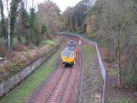 A tamping machine heads south at Kings Gate, just south of Sheriffhall, on 6th November 2014. The alignment of the original Edinburgh and Dalkeith railway trailed in from the right.<br><br>[David Spaven 06/11/2014]