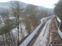 Looking north west towards Galashiels on 26 December 2014 over the site of Selkirk Junction. Part of the surviving abutment of the bridge that carried the Selkirk branch over the Gala Water is visible through the trees alongside the trackbed. The branch closed to all traffic in 1964.<br><br>[Ewan Crawford 26/12/2014]