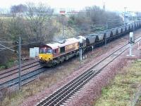 EWS 66233 finally gets underway following a lengthy signal check at the north end of Millerhill Yard in December 2002. The coal empties are destined for Ravenstruther. <br><br>[John Furnevel 10/12/2002]