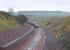 The day after reaching Scottish Borders Council territory, the rail-laying train inches south towards Falahill on 6 November 2014 - seen from the infamous Overbridge 41 [see Image 48014].<br><br>[David Spaven 06/11/2014]