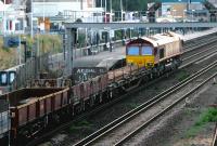EWS 66250 with an evening PW train passing north through Kensington Olympia on 21 July 2005. Amongst the vehicles is a wagon proclaiming Arsenal FC as <I>Kings of North London</I>. My own slightly mischievous cries of <I>'Come on you Spurrrrs...'</I> went unheeded by the train crew, but did succeed in turning one or two heads on Kensington High Street.<br><br>[John Furnevel 21/07/2005]