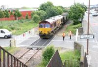 EWS 66078 brings coal empties from Cockenzie power station over Seafield level crossing on 9 June 2005 on their way to Leith Docks. View east from the pedestrian footbridge - note the smart new crossing gates!<br><br>[John Furnevel 09/06/2005]