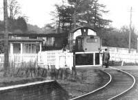 Opening the crossing gates over the A908 at Tillicoultry in October 1971. The train is carrying coal from Dollar mine, destined for Kincardine power station. Part of the platform of Tillicoultry station (closed 1964) is on the left. <br><br>[John Furnevel 07/10/1971]
