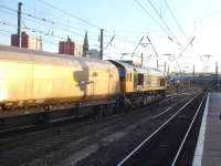 GBRf 66740 crosses from the up through line to the down side as it runs south through Doncaster Station on 13 January with a mixed rake of empty GBRf and former Fastline coal wagons.<br><br>[David Pesterfield 13/01/2015]