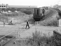 08793 awaiting the gates at Seafield level crossing on 25 July 1989 on its way from Millerhill depot to Leith South yard. [See image 50214]<br><br>[Bill Roberton 25/07/1989]