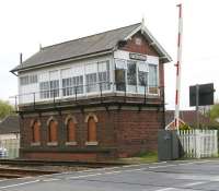 The stately-looking signal box at Strensall on the York - Scarborough line on 19 April 2009. View is south over Lords Moor Lane level crossing. <br><br>[John Furnevel 19/04/2009]