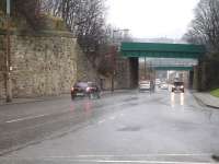 View east down Old Mill Lane, Barnsley, on a wet February day in 2015, showing the close proximity of the three bridges that once served the two main Barnsley stations. The abutment on the left once carried the MR line into Court House Station (closed in 1960). The two bridges beyond still carry lines to Barnsley (formerly Exchange) station, the nearest the MS&LR line to Penistone and the other the L&YR line to Wakefield Kirkgate.<br><br>[David Pesterfield 16/02/2015]