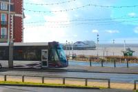Starr Gate bound <I>Flexity</I> 002 leaves the Blackpool coastline briefly to go behind the Metropole Hotel before calling at the North Pier tram stop. The long overhang at the front of the Bombardier trams is very noticeable in this side view. North Pier also had its own tramway, but only from 1991 to 2004 when it was unfortunately closed and then scrapped.<br><br>[Mark Bartlett 21/02/2015]