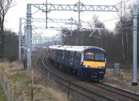 320321 on a Whifflet - Milngavie service passing the site of Tannochside Junction on 12 March 2015. The orange hi-viz jackets of construction workers building the M8 Braehead railway viaduct can just be seen in the left background.<br><br>[Colin McDonald 12/03/2015]