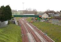 The last of the many new bridges to be built over the Borders Railway [see recent news item]. View is north towards Shawfair station in light rain on 12 April 2015, with work well underway. Part of the platforms and station footbridge at Shawfair are visible just beyond the new structure. Harelaw is on the right, with Newton village off picture to the left.<br><br>[John Furnevel 12/04/2015]