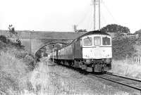 The 13:10 Waterloo to Exeter St. Davids (1V13) rolls through pleasant Devon countryside between Feniton and Whimple, where it was one of the few trains booked to stop. BRCW Type 3 No. 6540 is displaying the Southern Region route code for Waterloo - Exeter, although by the time of the photograph in 1972 the section of the former LSWR main line west of Salisbury was firmly in Western Region territory following the 1963 boundary changes. 	<br><br>[Bill Jamieson 15/09/1972]