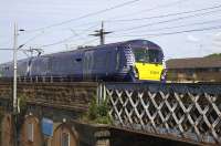 An Edinburgh - Helensburgh service crosses the bridge over Sandyford Street on its way to Partick on 9th June 2015. This stretch of line from Finnieston to Hyndland Junctions is very busy with up to 16 trains per hour each way at peak times.<br><br>[Colin McDonald 09/06/2015]