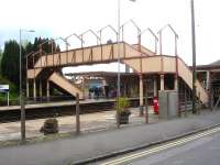 The now roofless footbridge at the north end of Yatton Station seen from the upside approach road on 10 May 2015. Note the half landings incorporated on each side of the bridge.<br><br>[David Pesterfield 10/05/2015]