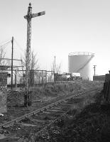 Looking east from the A955 level crossing over the Frances Colliery branch in 1983.  The Scottish Oils and Shell Mex depot in the background was served by a siding from the mid 1920s till the mid 1950s.<br><br>[Bill Roberton //1983]
