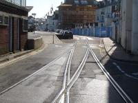 Looking along Custom House Quay from the junction with The Quay and Esplanade in May 2015, showing the check railed points on the disused Weymouth Tramway at the approach to the harbour station (behind the camera).<br><br>[David Pesterfield 12/05/2015]
