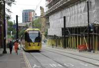 Double track working has been reinstated along Balloon St between Manchester Victoria and Shudehill. Additionally, all the setts are back in the roadway and the <I>Heras</I> fencing has been removed. Brand new tram 3099 drops down towards Victoria heading for Rochdale on 25th June 2015. [See image 48387] for the same location during the previous summer. <br><br>[Mark Bartlett 25/06/2015]