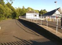 Looking south from the Loch Lomond end of the platform at Balloch Pier on 15 July 2015.  The platform and former station building both appear to have been well looked after. [See image 22314]<br><br>[Ken Strachan 15/07/2015]