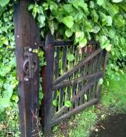 The crumbling edge of quality: the self-closing pedestrian gate to the Newcastle-bound platform at Brampton has lost its cable and weight. No doubt Network Rail have other priorities.<br><br>[Ken Strachan 17/07/2015]