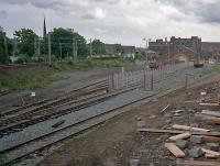 The monotony of the daily commute used to be slightly relieved by seeing what was in the yard at Partickhill. In latter days this was mostly engineering trains, as seen in this 1987 view. The yard had been re-ballasted and a secure area set up, probably for use with the Yoker resignalling trains. In the 1970s I recall tank wagons (perhaps en route to Bowling?) and burning piles which may have been from wagon disposal.<br><br>[Ewan Crawford //1987]